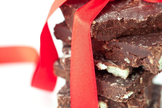 background of stack of chocolate with red ribbon