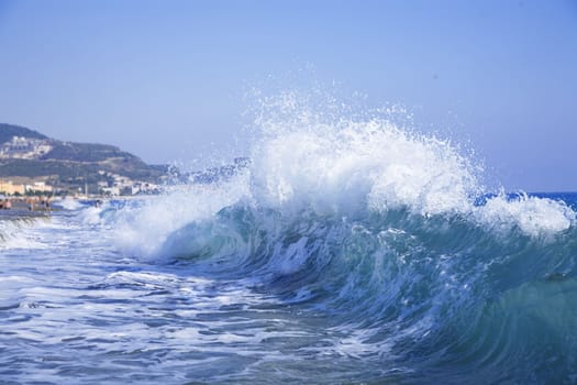 foamy big blue waves in a clear summer day