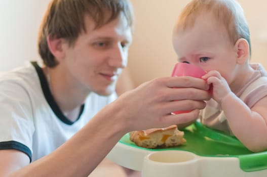 Father gives his daughter drink