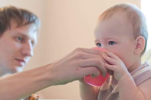 Father gives his daughter drink