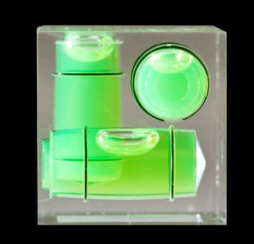 Three green spirit levels in plastic cube setting angle in any direction