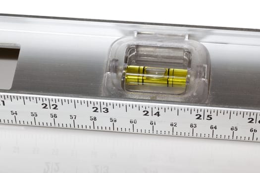 Yellow spirit level in aluminum measuring ruler in inches and cm