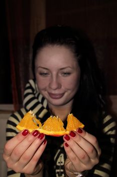 young woman with a slice of orange