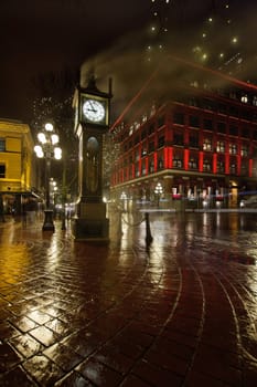 Gastown Steam Clock in Vancouver BC Canada on a Rainy Night with Historic Red Building