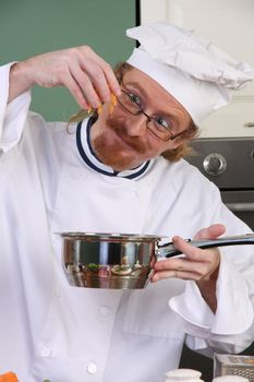 Funny young chef add carrots in the pot