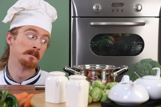 Funny young chef strange looking at pot