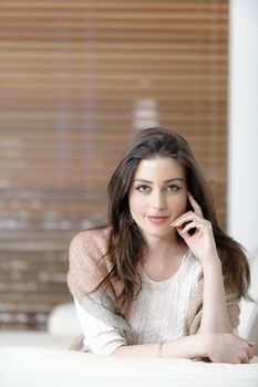 Beautiful woman relaxing in her elegant living room.