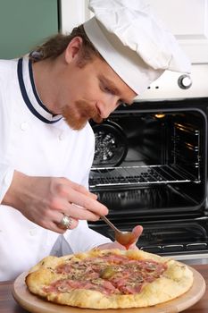 Young chef prepared italian pizza in kitchen