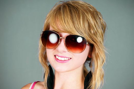 Pretty blond young woman with big sunglasses