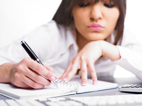 Happy Business Woman Writing in notepad