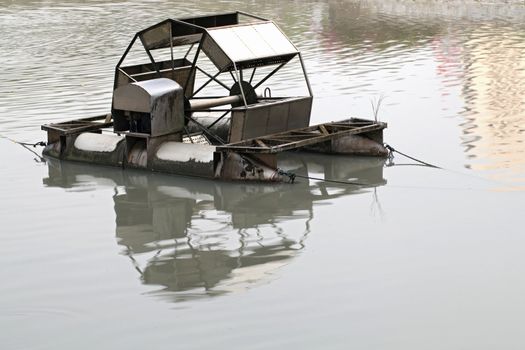 Metal wheel of watermill in Pond use for Add Oxygen for Industrial Sewerage System and water Treatment