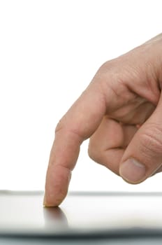 Side view of male finger working on a tablet computer. Over white background.