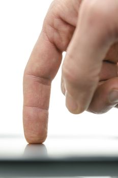 Side view of male finger using mobile smart phone. Over white background.