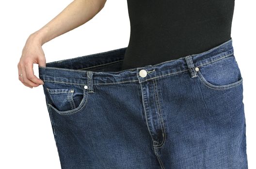 Front view of slim woman in black shirt and over sized jeans. Over white background.