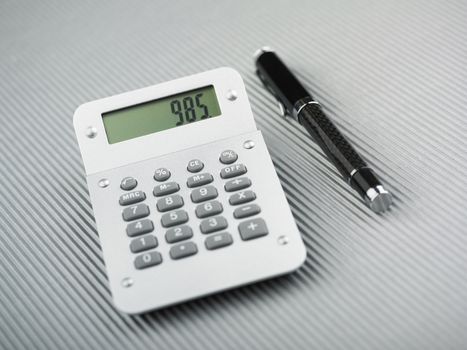 Calculator and pen on office table