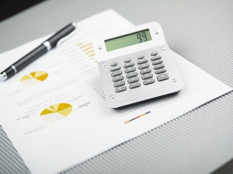 Market Analyze - pen and calculator on papers