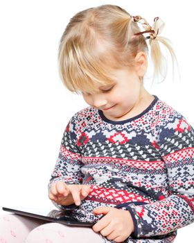 Portrait of 4 years girl using a touch pad