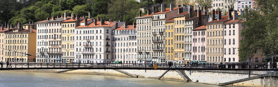 footbridge and series of colorful buildings in Lyon city