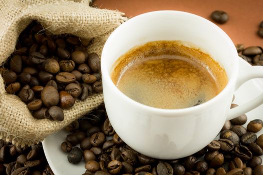 Coffee beans in a juta bag and cup