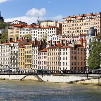 Image shows a series of colorful buildings in the city of Lyon