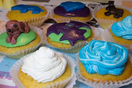 Some colored cupcakes with cream