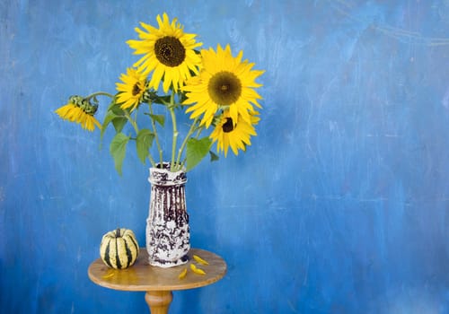 retro vase with sunflowers and blue background