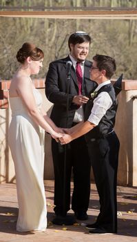 Couple standing and holding hands for wedding ceremony