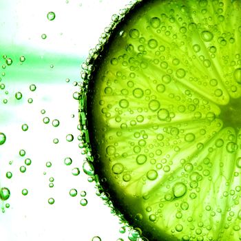 lime slice in water bubbles