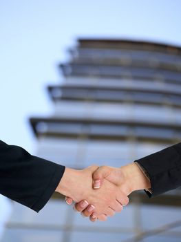 Handshake Handshaking and blured building in background