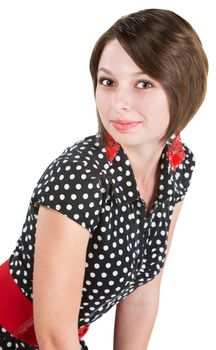 Beautiful young woman in polka dot dress leaning over