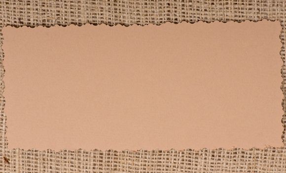 Old paper tag on natural burlap