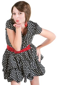 Cute young lady in polka dots blowing kisses