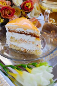 Piece of cake with apricot and tea