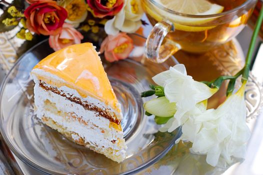 Piece of cake with apricot and tea