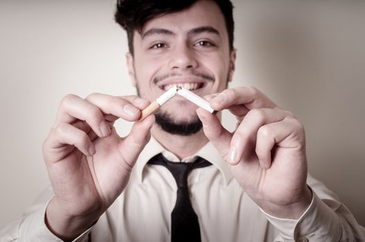 businessman stop smoking on gray background