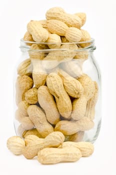 A jar full of unpeeled peanuts on a white background