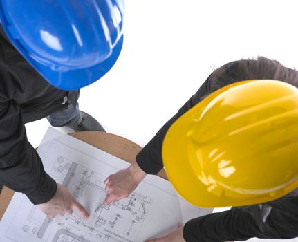 Two architects with hard hats and plan on meeting in office