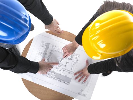 Two architects with hard hats and plan on meeting in office