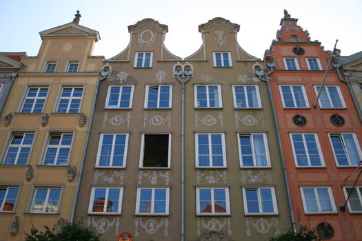 Facade of several old european colored houses standing nearby