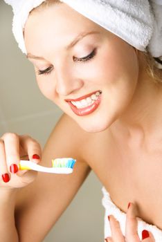 beautiful young woman  brushing her teeth in the bathroom