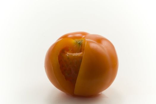 Red tomato on white background. Close-up.