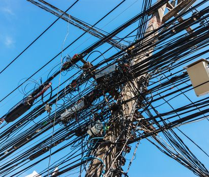 Intertwining of many electrical wires on poles