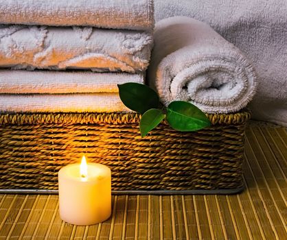 Spa with towels with a candle and other accessories