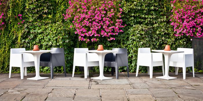 A modern set of tables and chairs outside a building