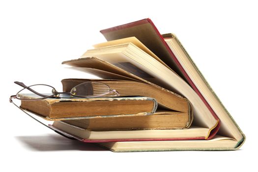 Group of Old Antique Books and eyeglasses isolated on white