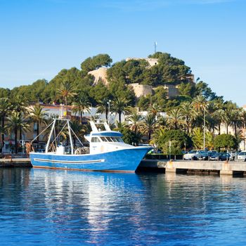 Denia mediterranean port village with castle mountain and blue sea water