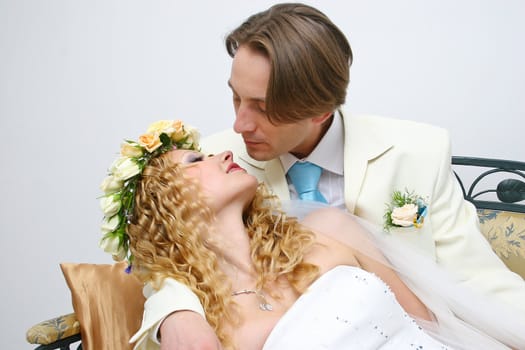 Young couple posing in a studio on the wedding day 