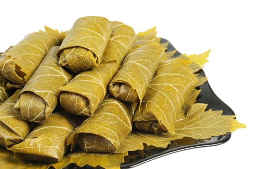 Dolma on a black plate. Isolated on white background.