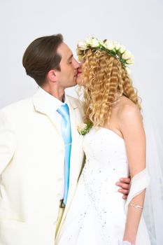 Young couple posing in a studio on the wedding day 