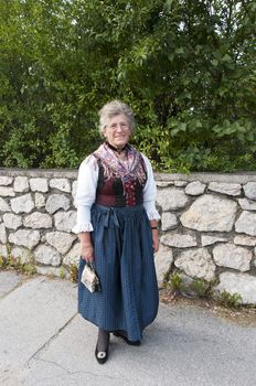 AXAMS,AUSTRIA - AUGUST 15:Unidentified woman showing traditonal dress,on August 15, 2012 in Axams, Austria.This dress is worn only at  Maria Ascension is the annual christian celebration in Axam